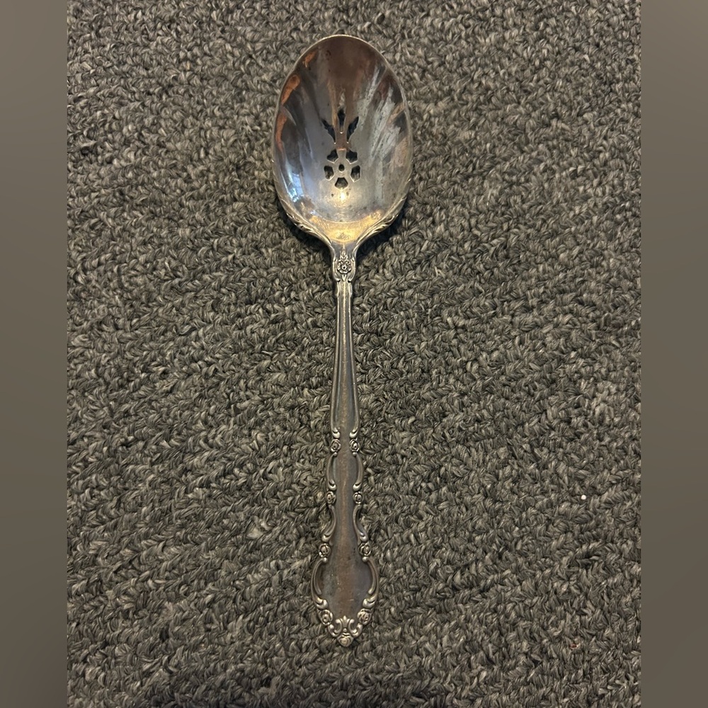 Heirloom sterling grandeur pierced table serving spoon.